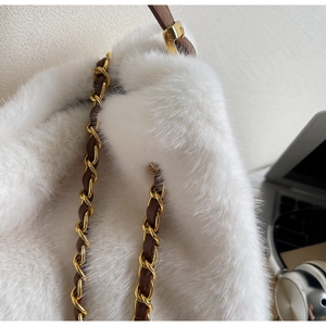 Detail of white faux fur handbag with premium mink texture and gold chain leather strap