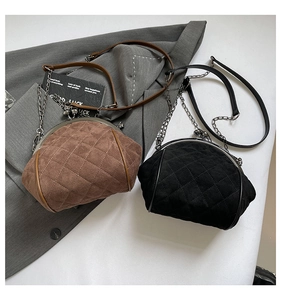 Detail view of vintage quilted clasp bags in brown and black with chic metal chain straps