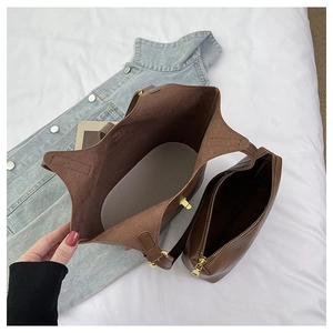 Top view of large brown tote bag interior with matching zipper pouch and gold hardware