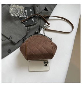 Detailed view of brown quilted suede chain bag with retro clasp and phone for scale