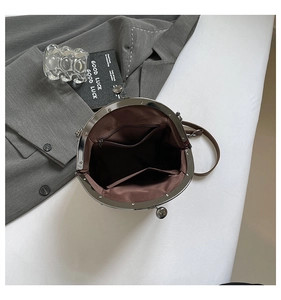 Top view of retro brown clasp bag interior with zip pocket and fabric lining