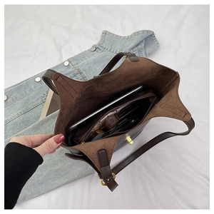 Internal view of dark brown tote bag showing large capacity and inner zipper pocket