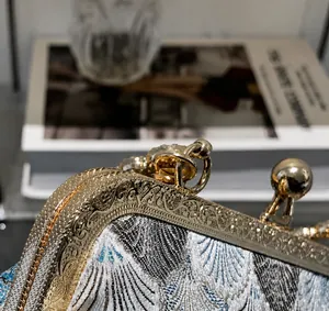 Detailed macro of golden floral engraved metal clasp on retro brocade handbag