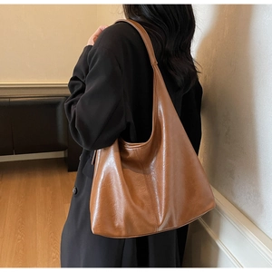 Brown soft leather Hobo bag with reinforced stitching details on the side for daily use