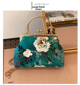 Detail of peacock green floral qipao bag with gold handle and metal clip closure