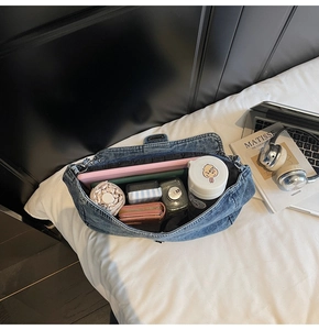 Detail view of large capacity denim shoulder bag showing spacious interior with daily essentials
