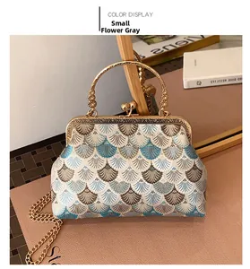 Detailed embroidery of shell patterns on vintage Chinese style handbag with golden frame