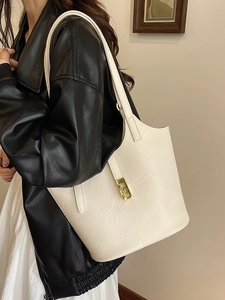 Minimalist beige tote bag in textured faux leather with gold buckle for daily commuting