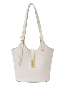 Off-white leather tote bag with gold swivel buckle and adjustable shoulder straps