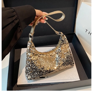 Close-up of sparkling gold and silver sequins on a trendy hobo bag with a leather strap