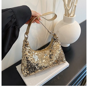 Close-up of golden sequins texture and metallic zip on the crescent hobo bag