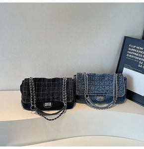 Detail view of vintage denim quilted bags with silver chain straps and metal twist locks