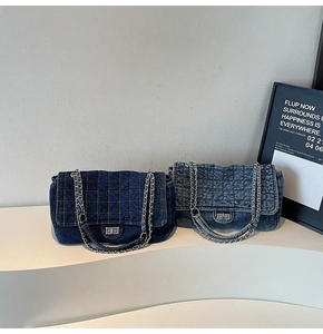 Detail of denim quilted chain bags in dark and light blue with silver twist locks