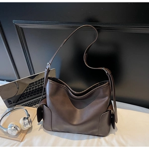 Detail showing high-quality dark brown PU leather texture and side pocket of the tote bag