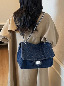 Quilted denim chain bag in dark blue with silver twist-lock and shoulder strap