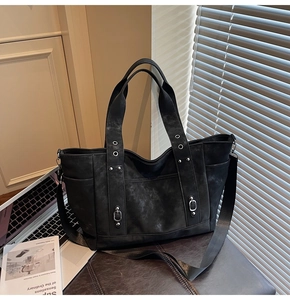 Detailed macro view of matte vintage tote bag with metal rivets and canvas shoulder strap