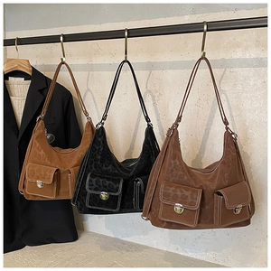 Detail of hobo tote bag featuring leopard embossing and multiple cargo flap pockets