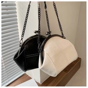 Detail of vintage kiss-lock shell bags with cross stitching and metal chain straps