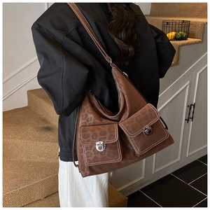 Brown leopard print suede hobo bag with front flap pockets and white contrast stitching