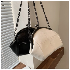 Detail of vintage clamshell handbags with metal kiss-lock and elegant chain straps