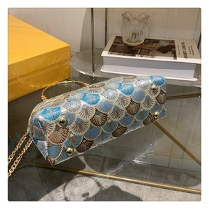 Detail view of the vintage jacquard bag showing protective gold metal feet on bottom