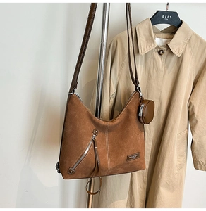 Brown suede hobo bag detail with white stitching and detachable round coin purse