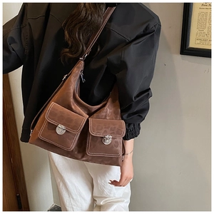 Detail of vintage brown tote bag featuring leopard print texture and twin front metal buckles