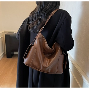 Detail shot of a dark brown PU leather tote bag with unique textured hammock structure