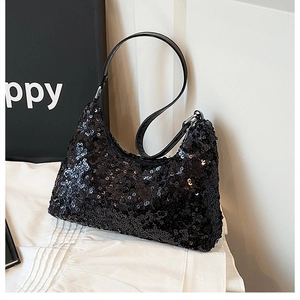 Detailed close-up of high-density black sequins and silver buckle on a crescent bag