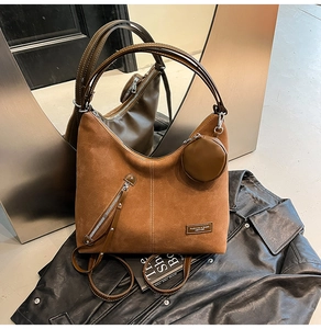 Brown suede Hobo bag featuring a front diagonal zipper pocket and a round coin purse