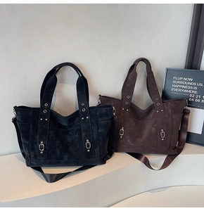 Detail of vintage canvas tote bags in black and coffee with silver metal buckles