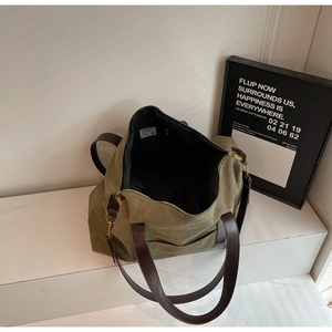 Close-up of olive canvas tote bag interior with black lining and durable metal zipper