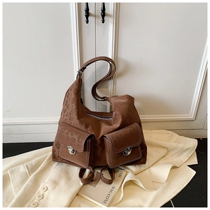 Detail of dark brown leopard print shoulder bag with metallic buckles and pockets