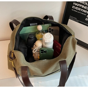 Detail shot showing the large capacity of the olive green canvas tote bag for daily essentials