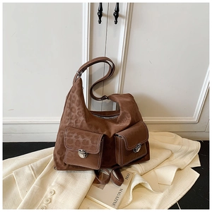 Detail of brown leopard print suede hobo bag with dual front pockets and metal buckles