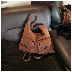 Detail of a brown leopard print hobo bag with vintage metal locks and front pockets