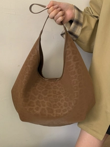 Vintage brown hobo tote bag with leopard print texture and minimalist shoulder strap