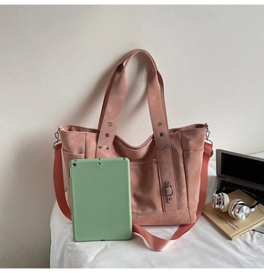 Detailed view of the dusty rose pink tote bag with wide strap and multiple pockets