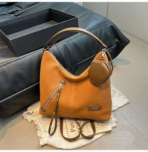 Detail of caramel suede hobo bag featuring contrast stitching and detachable coin purse