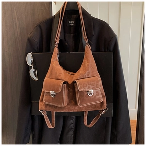 Detailed view of vintage leopard-embossed brown bag with large front pockets and silver buckles
