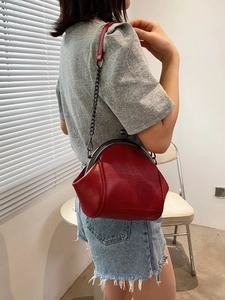 Chic red shell bag with chain strap and retro clasp closure for women crossbody wear