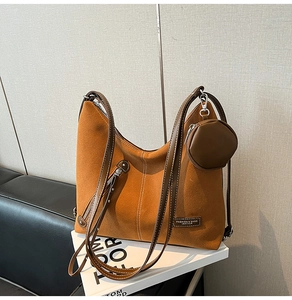 Detail showing the brown suede tote bag with silver zipper and mini round coin purse