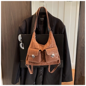 Detail of brown leopard print bag featuring two front pockets with silver metal buckles