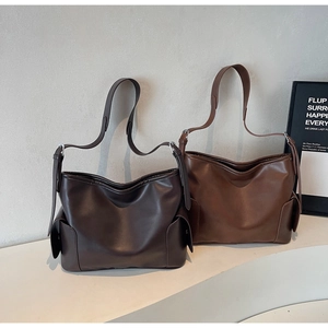 Detail view of large PU leather tote bags in dark brown and coffee with side pockets