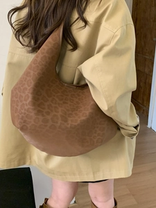 Brown leopard print hobo bag in matte finish, large shoulder tote shown on model