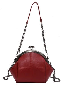 Classic red shell crossbody bag with metal chain strap and spherical clasp closure