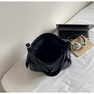 Top view of large black PU tote bag showing spacious interior and side flap pockets