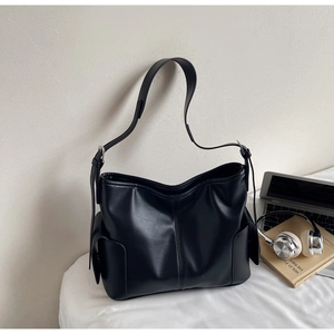 Detail of black PU leather hobo bag with side flap pockets and adjustable strap