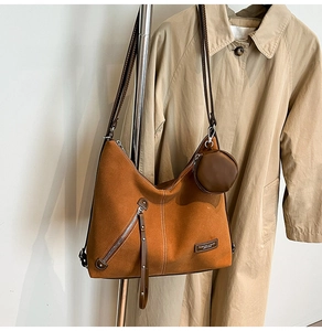 Detailed macro view of ginger suede tote bag texture with fashion label and tassel