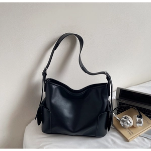 Detail view of the black PU leather hobo bag with side pockets and metal strap buckle